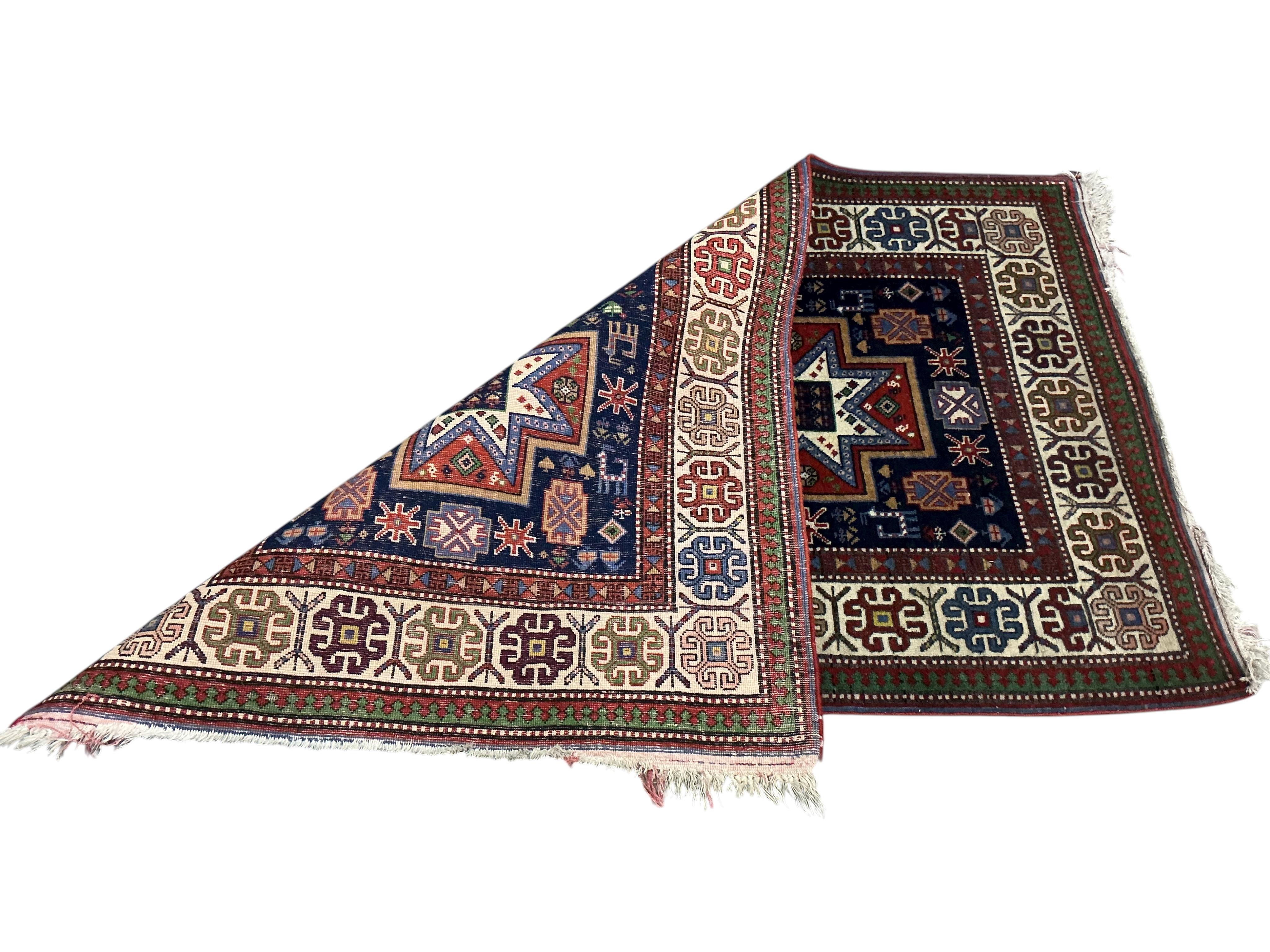 A Caucasian Kazak blue ground geometric rug, 128 x 80cm